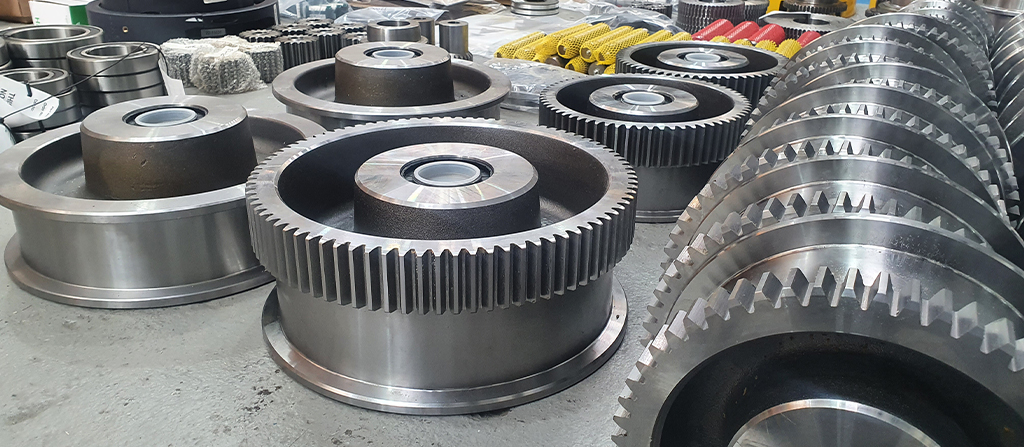 A collection of crane parts on the floor of a warehouse