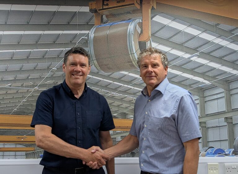 Image shows SCE Group Deputy Chairman, Ray Fletcher, and Chairman Simon Eastwood shakings hands to congratulate Ray on his recent promotion.